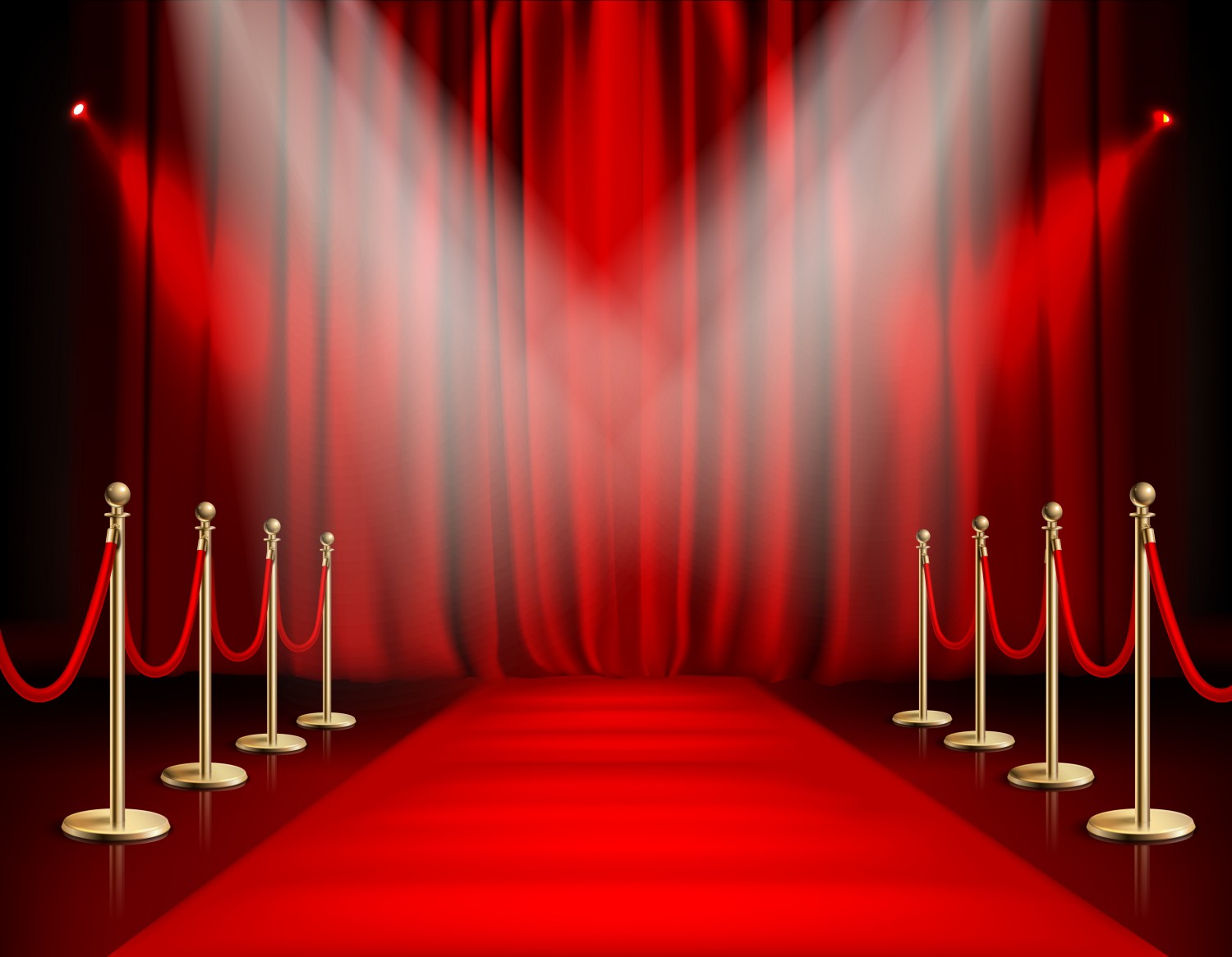 Red carpet lined with golden barrier ropes leading to a spotlit curtain
